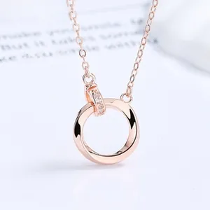 Macro shot of rose gold Mobius interlocking rings pendant necklace with small diamonds