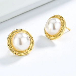 Close-up of gold twist texture earrings with round white pearls on a white background