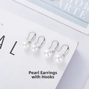 Detailed view of white shell pearl ear hooks on elegant 925 sterling silver jewelry base
