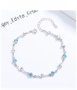 Macro view of S925 sterling silver ocean heart bracelet with light blue crystals and lobster clasp