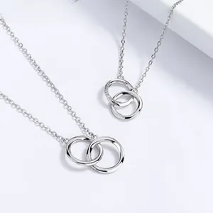 Macro detail of interlocking double rings pendant on a fine S925 sterling silver chain