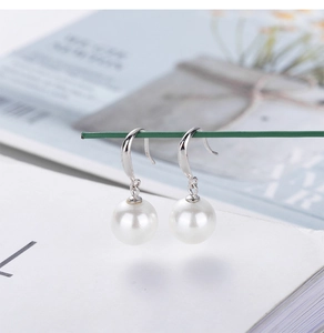 Macro view of 925 sterling silver hooks with lustrous round white pearls