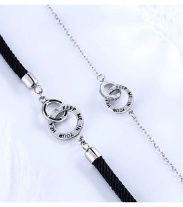 Detail of S925 silver interlocking rings on black braided rope and chain for couples