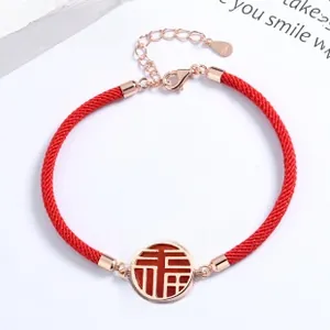 Detail of red braided S925 silver bracelet with Fu pendant and lobster clasp