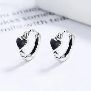 Detailed macro view of S925 sterling silver hoop earrings with black enamel hearts