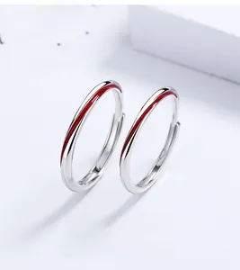 Macro shot of silver Mobius couple rings featuring a delicate red inlay line
