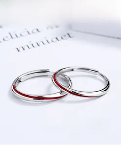 Macro view of adjustable S925 sterling silver Mobius rings with red enamel line