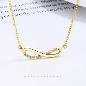 Close-up of gold infinity charm bracelet featuring pavé set cubic zirconia and fine cable chain