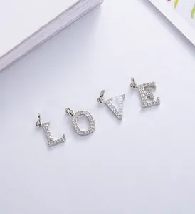 Macro detail of LOVE letter pendants with zircon inlay on S925 silver necklace