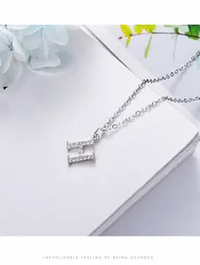 Close-up of S925 sterling silver H-letter pendant necklace with white pavé crystals