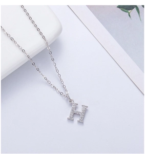 Close-up of S925 sterling silver letter H pendant necklace with sparkling white zircons