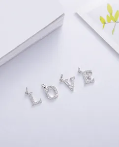 Detailed view of S925 silver LOVE letter pendants with micro-pave cubic zirconia crystals