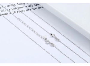 Macro view of S925 sterling silver water wave chain with adjustable lobster clasp