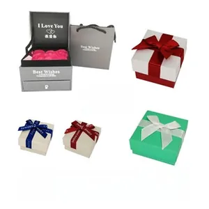 Variety of luxury jewelry gift boxes with ribbons, preserved flowers, and polishing cloth