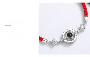 Detailed macro view of 925 sterling silver red woven rope bracelet with I love you projection