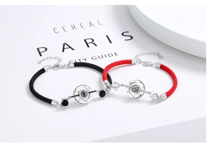 Macro shot of 925 sterling silver S925 engraved clasp on red and black braided bracelets