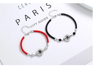 Detail of 925 sterling silver couple bracelets with woven rope and Roman numerals