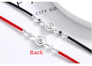 Detail view of red and black woven couple bracelets with S925 silver square hole charms