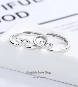 Macro shot of S925 sterling silver couple rings with wavy golden hoop design detail