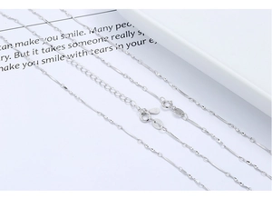 Macro view of S925 sterling silver twist chain necklace with spring ring and logo tag