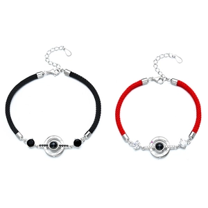 Silver projection bracelets for couples with Roman numerals on red and black braided ropes