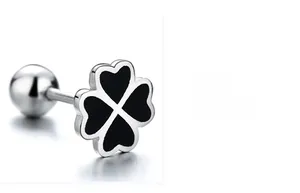 Macro shot of silver clover screw-back earring with black enamel and heart-shaped petals