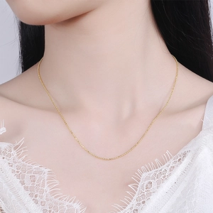 Elegant s925 silver beaded choker in gold finish worn on a white lace collar
