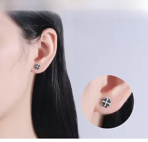Detailed view of black clover stud earrings with S925 sterling silver frame on model
