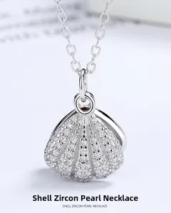 Macro shot of silver shell pendant with shimmering pavé zircon and a central white pearl