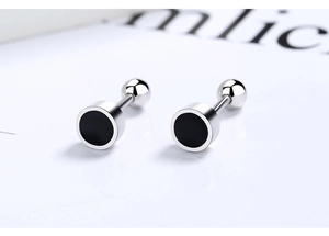Macro shot of silver stud earrings with black enamel clover and screw-back closure