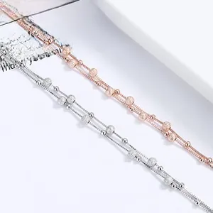 Detailed close-up of 925 silver double-layer beaded bracelet in silver and rose gold