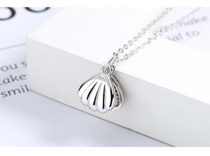 Macro view of S925 sterling silver shell pendant showing authentic material hallmark