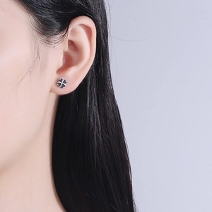 Minimalist black four-leaf clover stud earring in S925 silver on model's ear