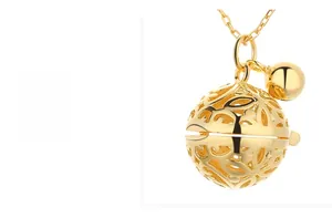 Detailed macro view of S925 sterling silver hollow bell pendant with gold finish
