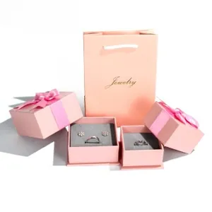 Pink jewelry gift set with branded paper bag and ribbon boxes with velvet inserts