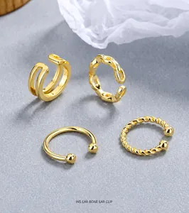 Set of four gold-plated ear clips featuring smooth, chain, and twisted rope textures