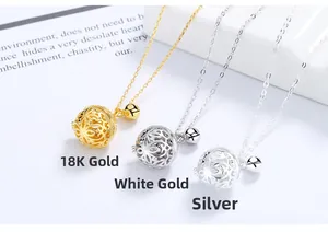 Three hollow bell pendants in gold, silver, and white gold plating on O-chains