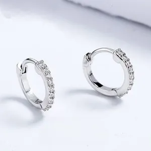 Close-up of small silver hoop earrings with clear micro-pave cubic zirconia crystals