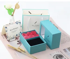 Detailed gift set featuring Tiffany blue jewelry box with red roses and matching gift bag