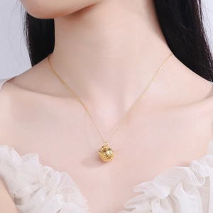 Elegant gold hollow bell pendant necklace with intricate floral patterns for women