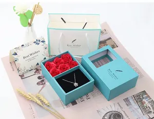 Blue jewelry gift box with red roses and a silver snowflake pendant necklace set