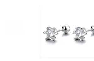 Macro shot of silver screw-back zircon earrings with a classic six-prong setting