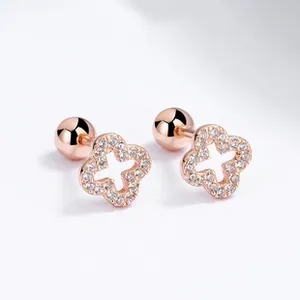Macro shot of rose gold sunflower earrings with white zircons and screw ball back