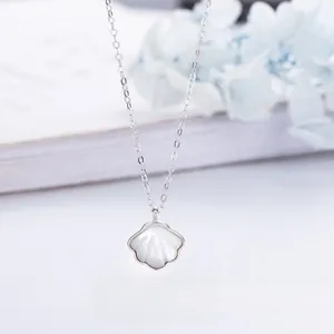 Detail of 925 sterling silver necklace featuring a shell-shaped white mother of pearl pendant