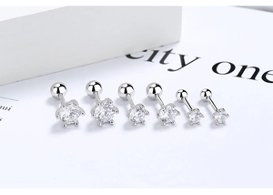 Macro detail of three pairs of S925 silver six-prong cubic zirconia screw-back stud earrings
