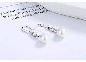 Close-up of S925 sterling silver pearl drop earrings with sparkling cubic zirconia accents