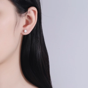 Classic round 925 sterling silver 6-prong stud earrings with brilliant zircon on a model
