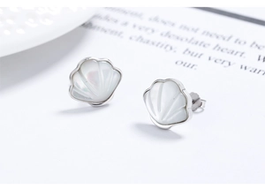 Detail of shell-shaped S925 silver stud earrings with natural white mother of pearl inlay