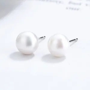 Close-up of elegant baroque pearl earrings with shiny finish and silver metal studs