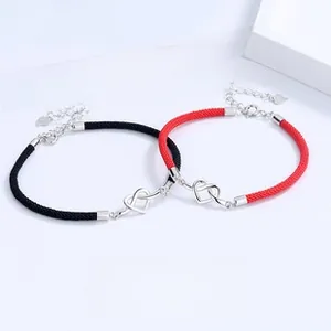 Detailed view of S925 silver Mobius heart charm on woven couple bracelets set